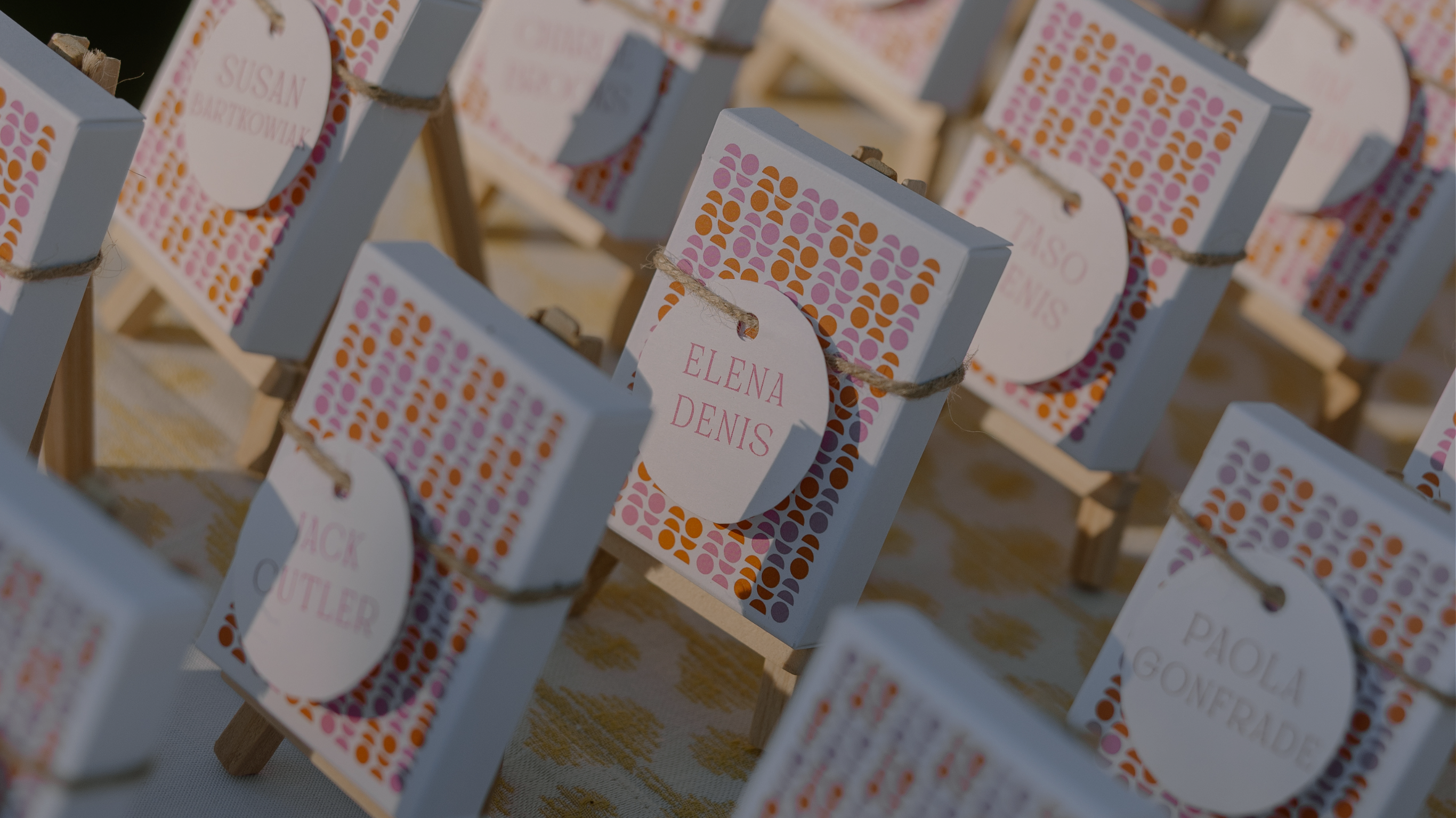 Decorative name tags on custom design pink and orange matchboxes. 