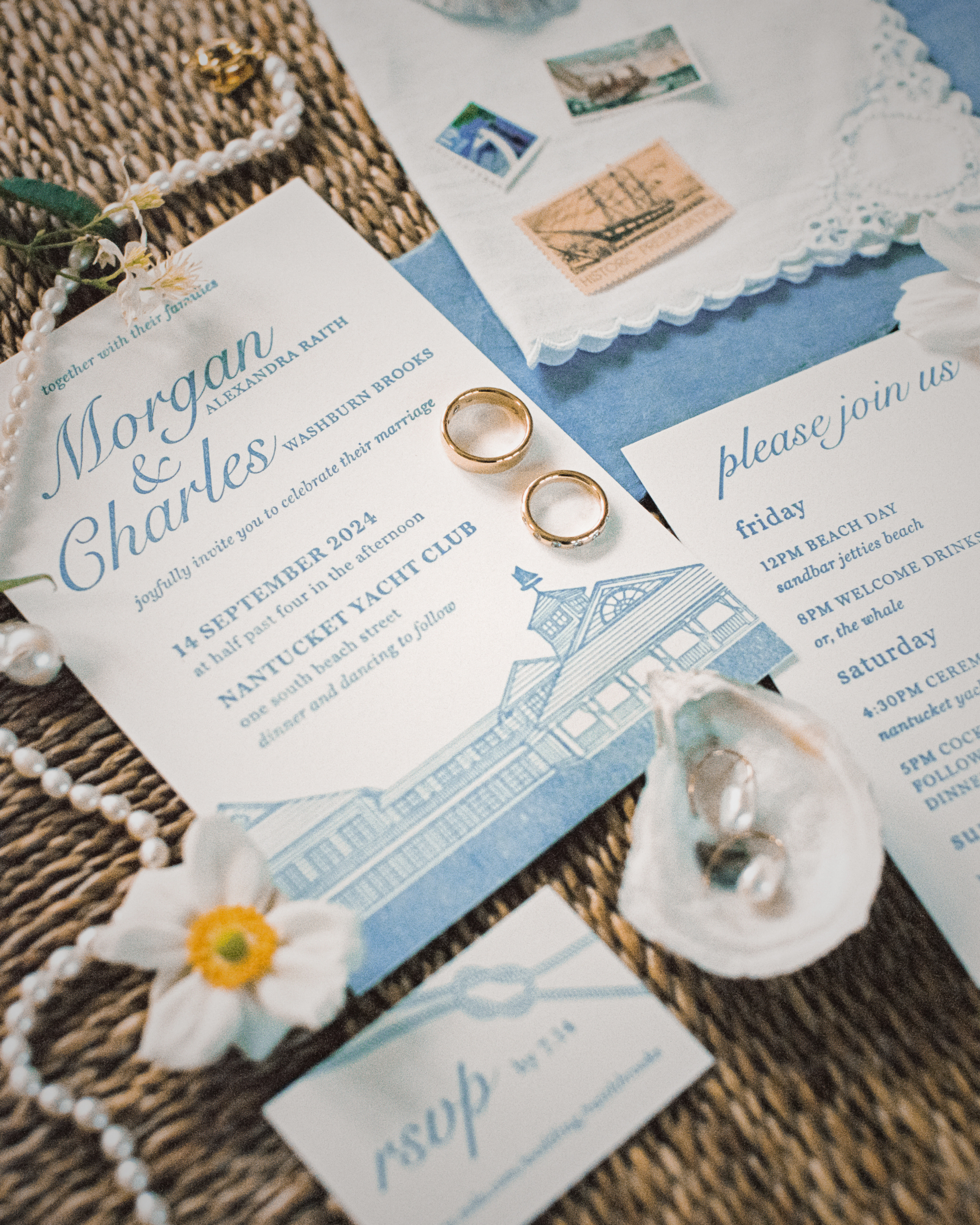 Wedding invitation with rings and decorative elements on a textured surface