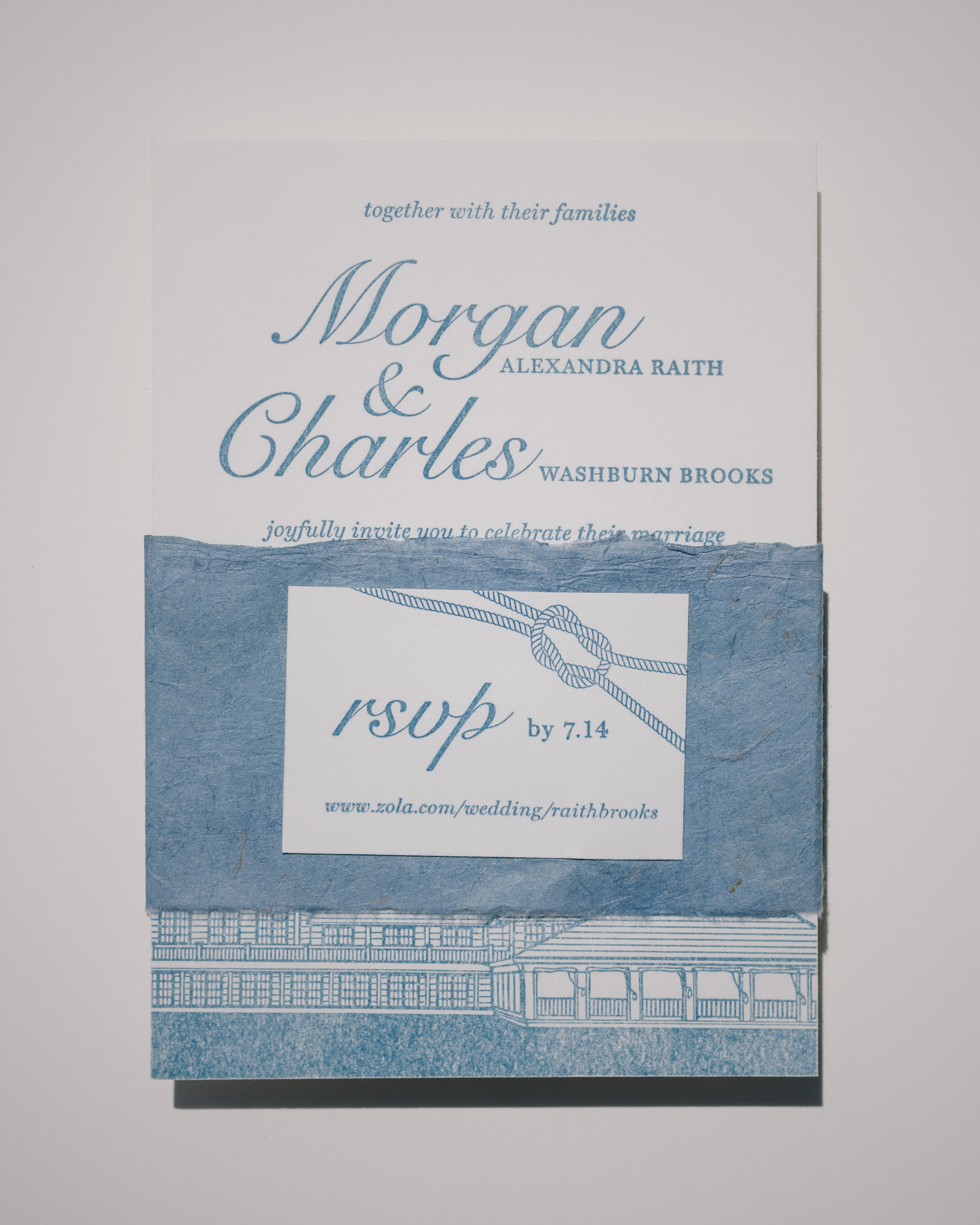 Wedding invitation with blue and white design on a gray background