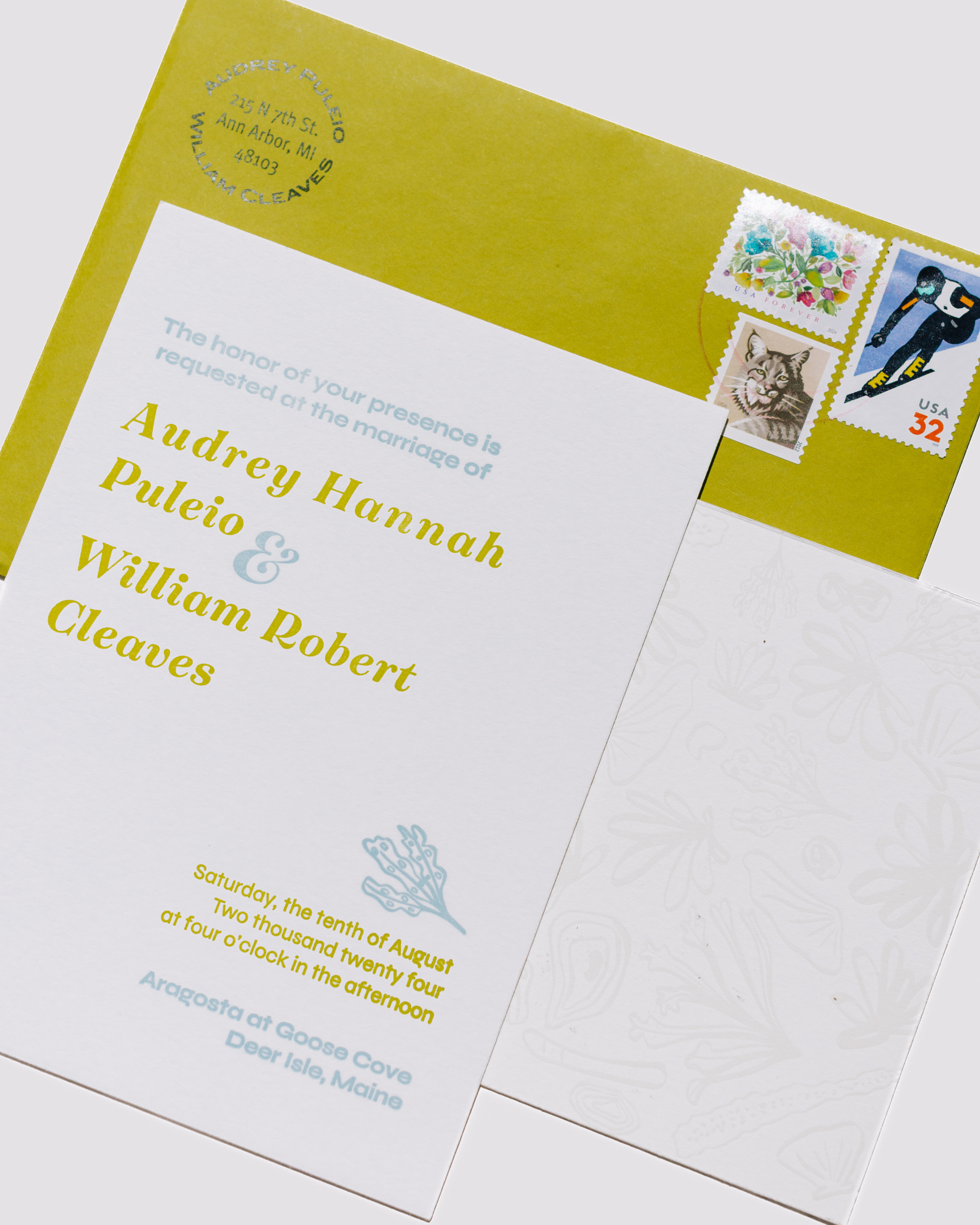 White wedding invitation with yellow text and blue illustrations on a white background