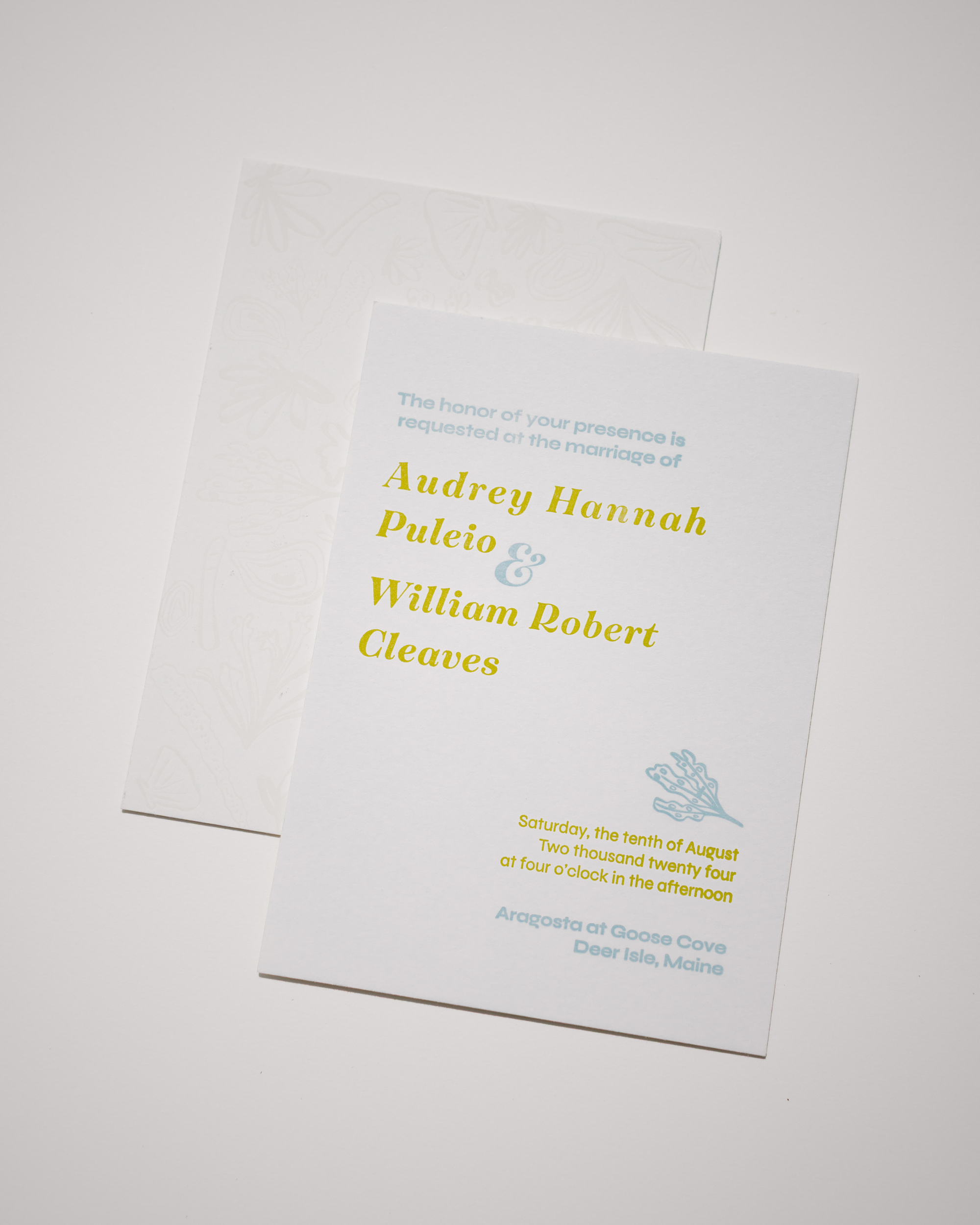 White wedding invitation with yellow text and blue illustrations on a white background