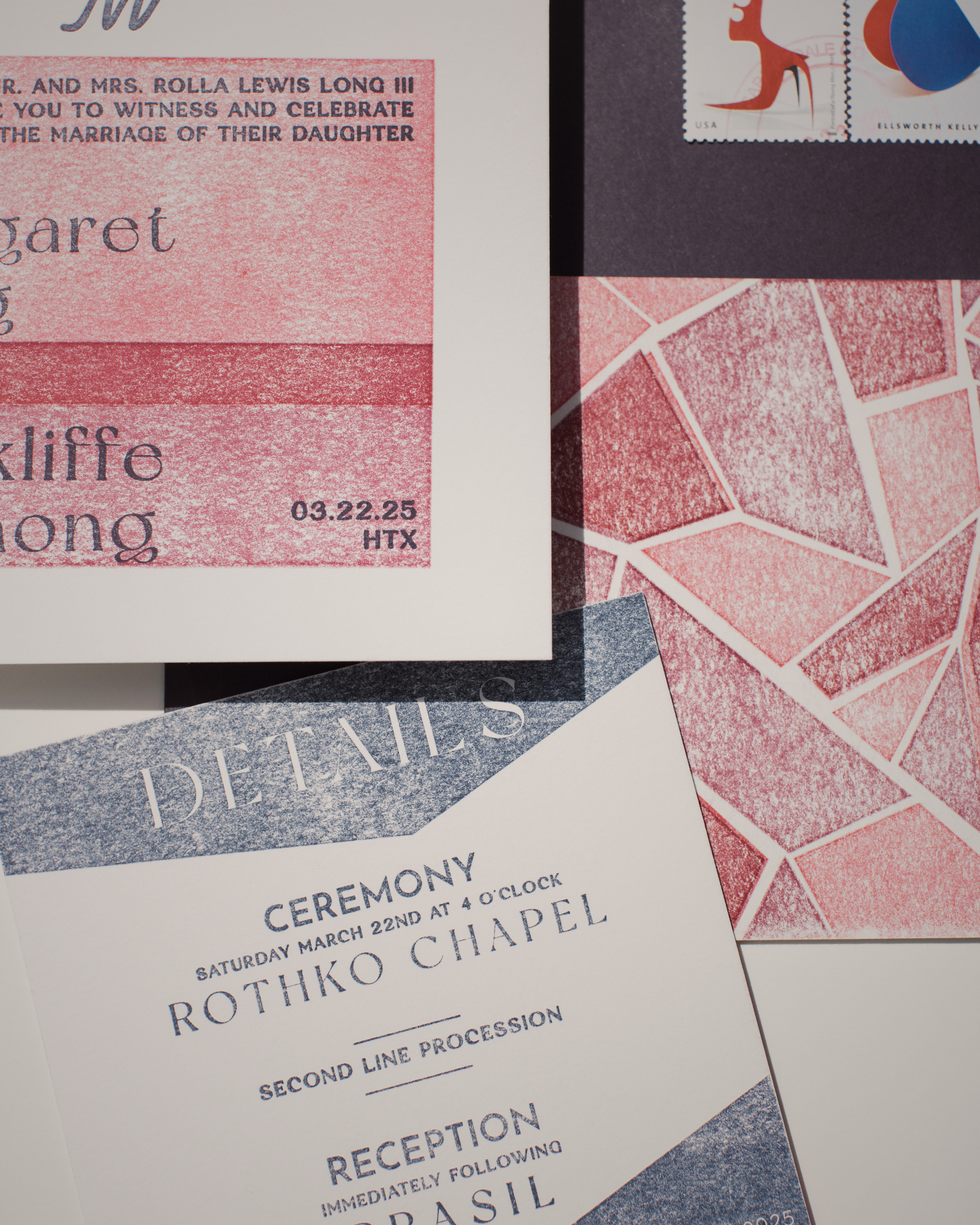Wedding invitation with pink and blue design elements on a textured surface