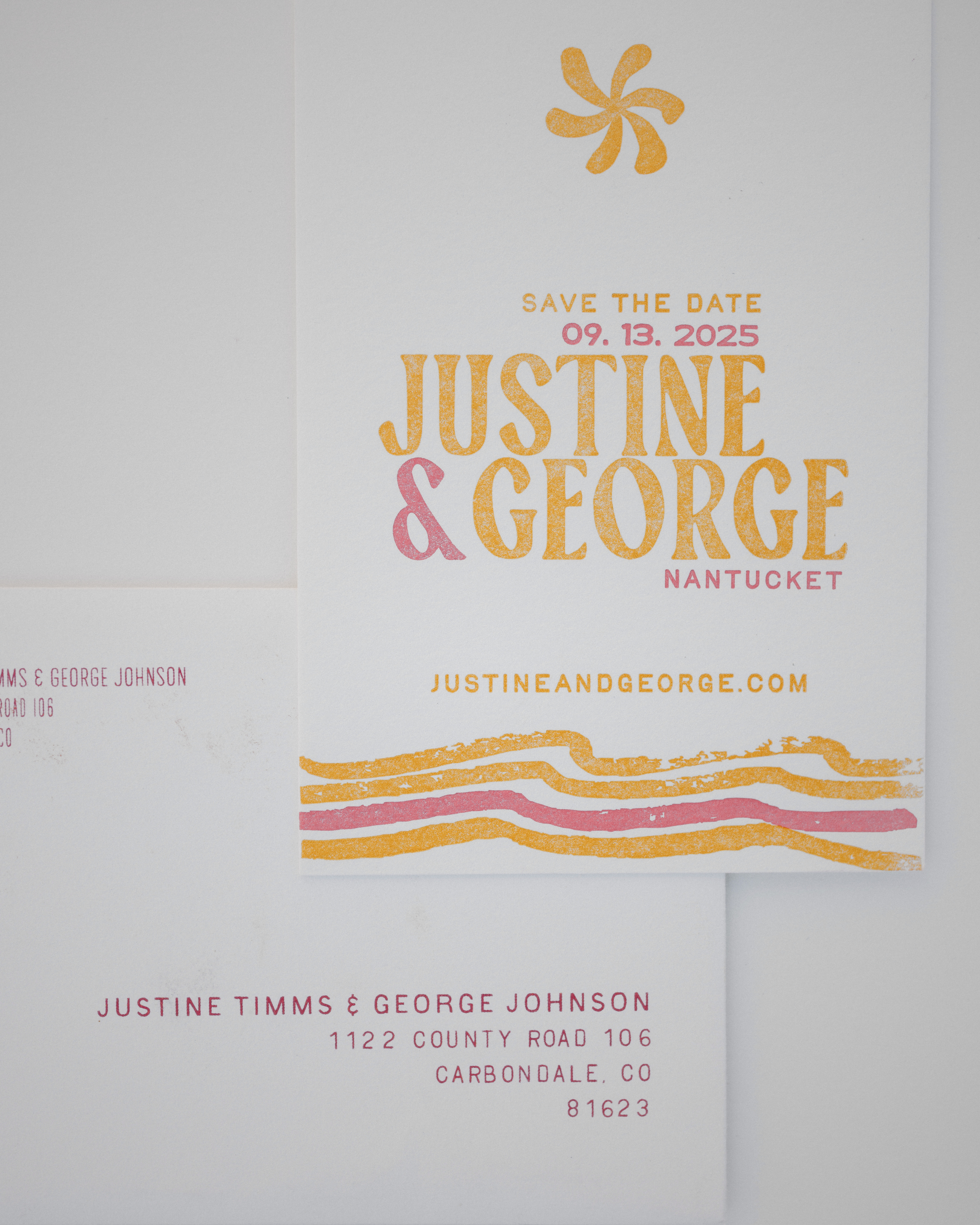 Wedding save the date card with colorful text and abstract designs on a light gray background