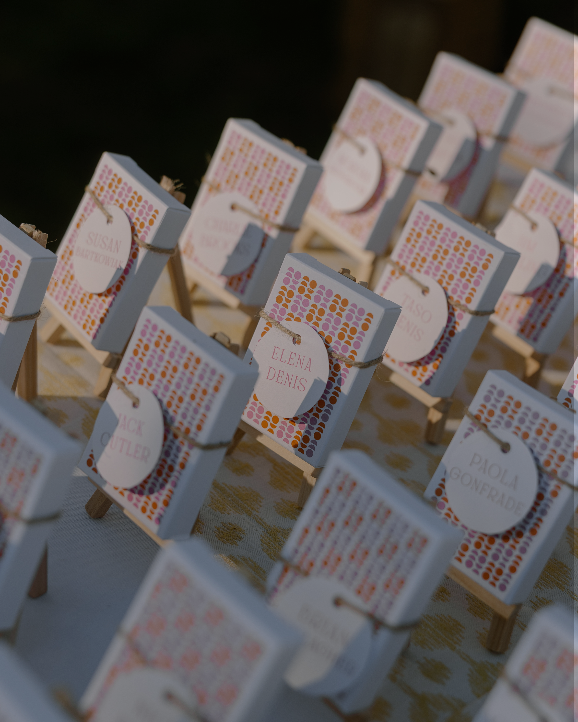 Decorative name tags on custom design pink and orange matchboxes. 