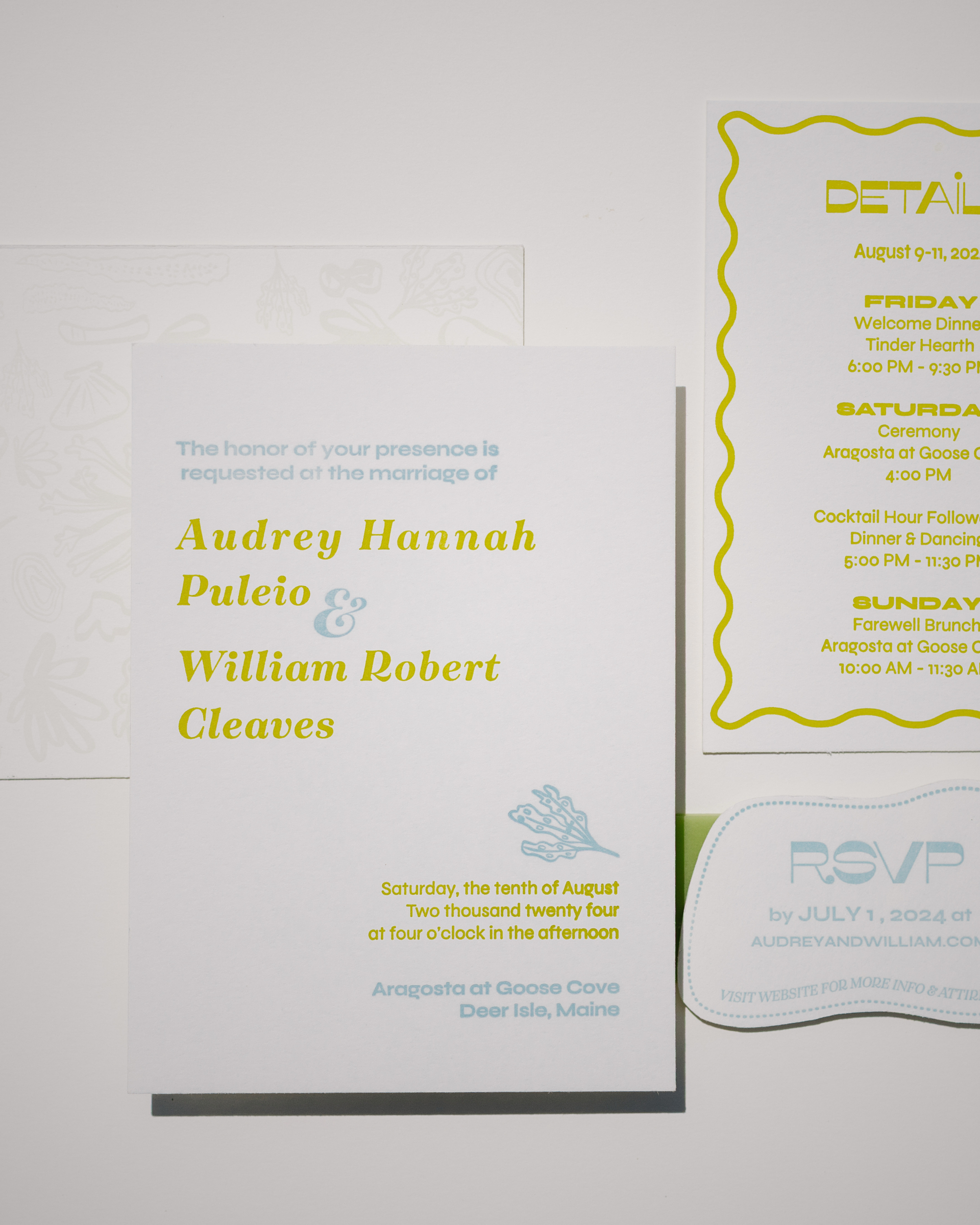 Wedding invitation card with text and RSVP card on a light gray background