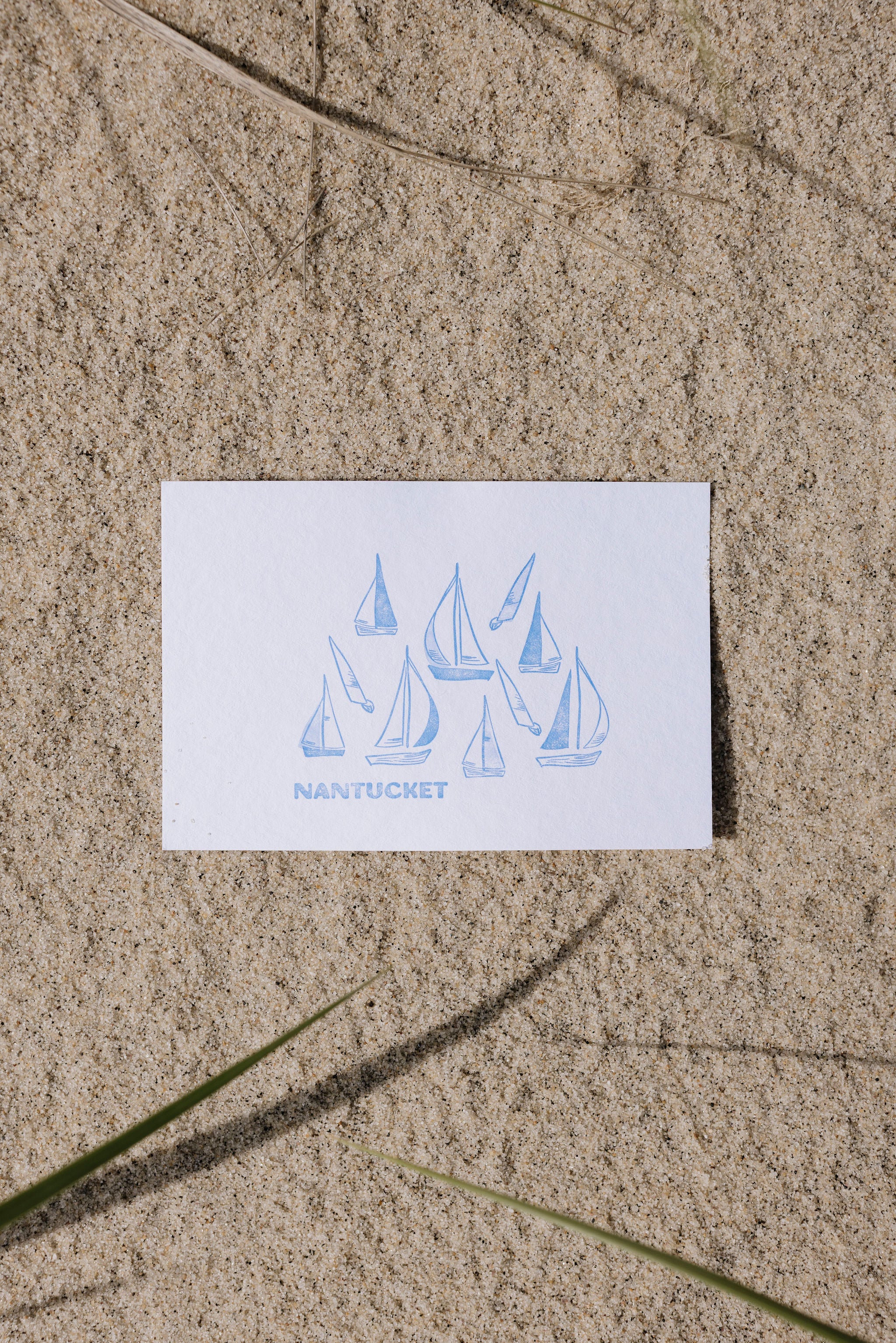 Nantucket card with sailboat design on sand
