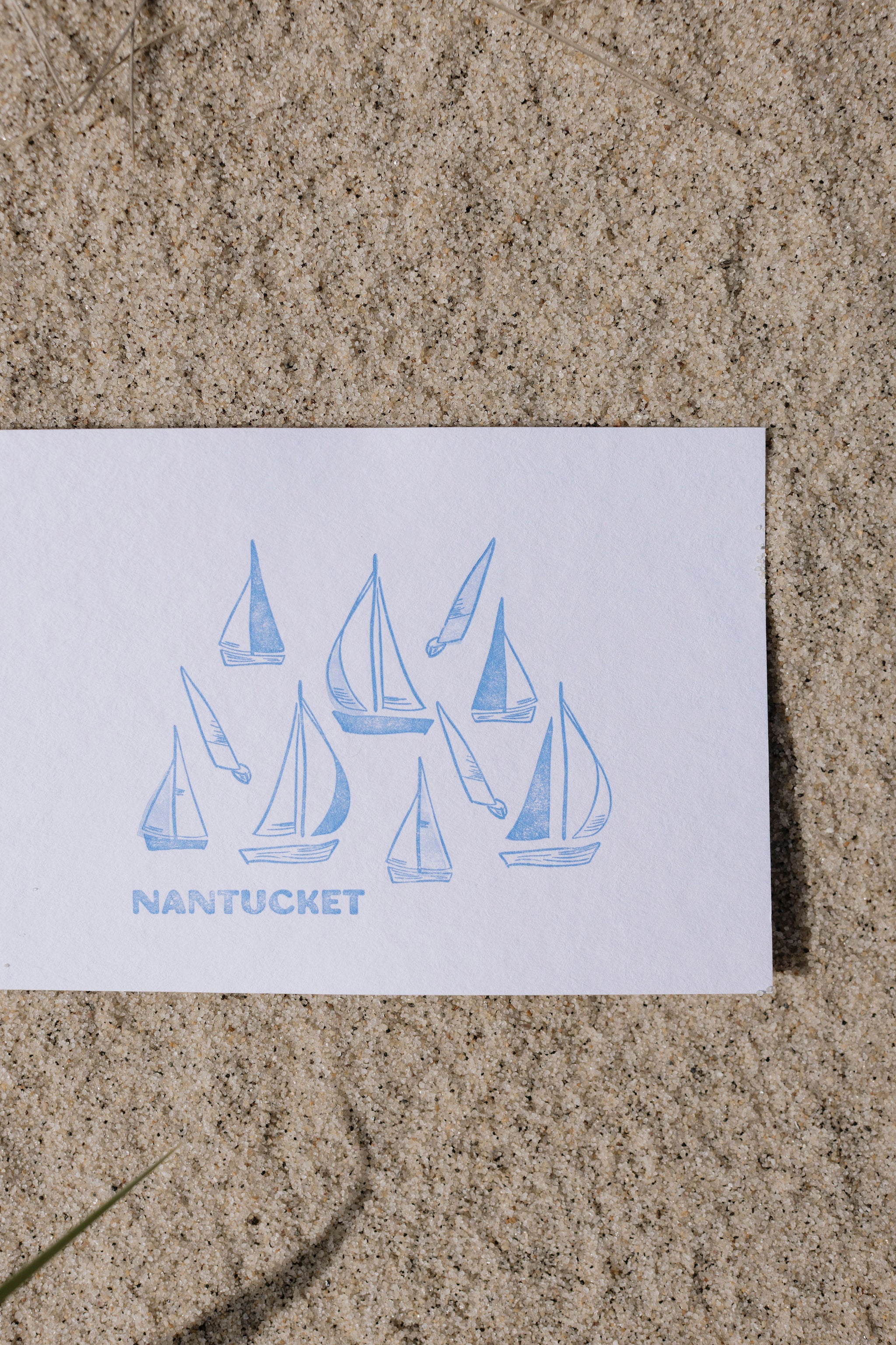 Nantucket card with sailboat design on sand