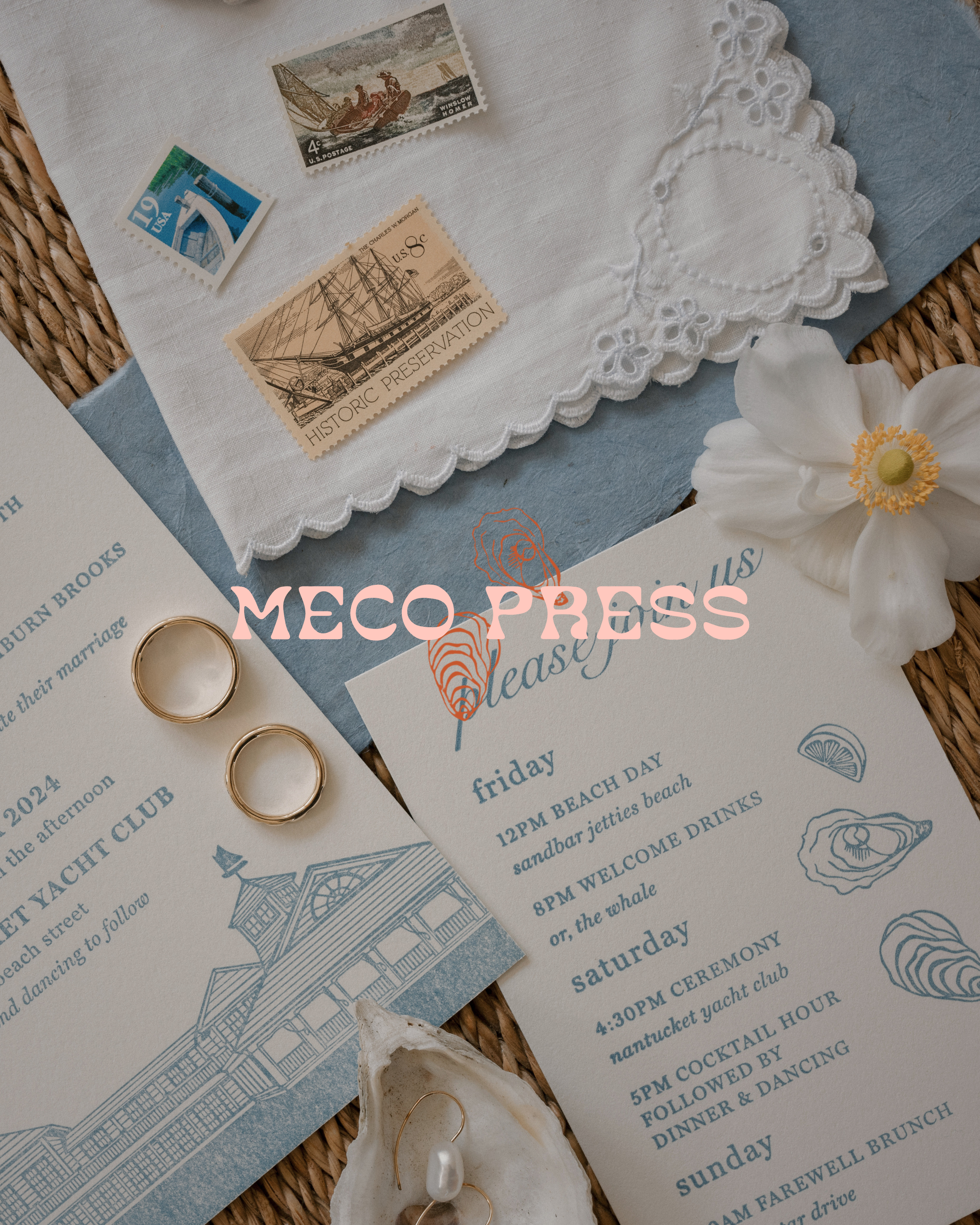 Wedding invitation with rings, seashells, and a flower on a textured surface with 'Meco Press' branding.